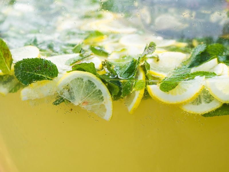 Cold craft lemonade with ice and lemon slices